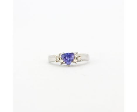 A 14ct white gold (stamped 14k) ring set with a trillion cut tanzanite and brilliant cut diamond set shoulders, (K.5).