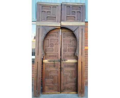 A pair of large Oriental carved pine doors with arched side frames, door H. 200cm.