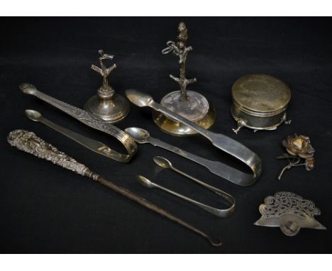 A pair of George III silver sugar bows, bright cut; two others, similar, later; a novelty ring stand surmounted with an ape; 