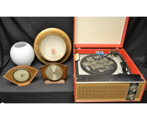 A mid-20th century R.E.A.L. Plinth Light; an oil lamp globe; a retro electric mantel clock; another, similar; an Ultra portab