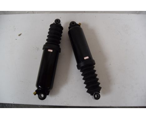 A pair of shock absorbers, believed to be for a Harley Davidson