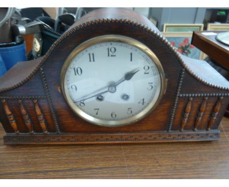 An Art Deco French French mantle clock, oak case, silvered dial with Arabic numerals