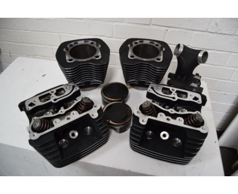 A pair of used harley Davidson barrels, heads and pistons.
