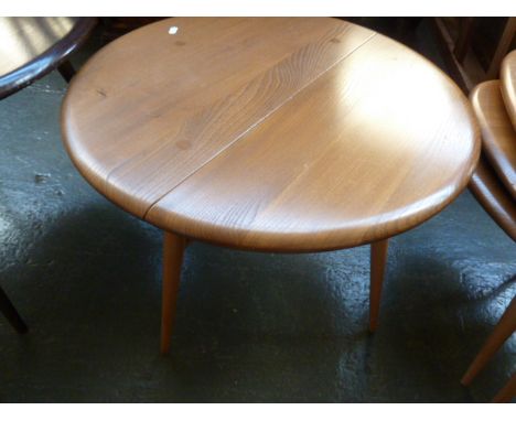 An Ercol light elm drop flap circular table, 60cmDiam