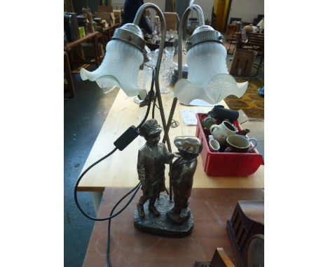 An Art Deco style Widdop Bingham & Co desk lamp, of boy and girl on naturalistic base, with two frosted flower shades, with a