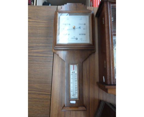 A walnut cased wall barometer, with weather gauge and temperature
