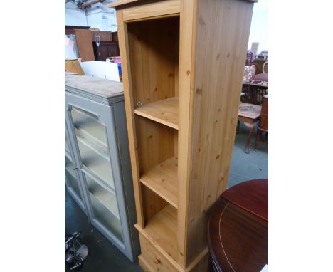 A narrow pine shelf unit, two shelves over drawer on carved bracket feet, 44cmW