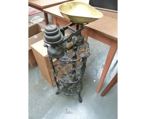 A black painted cast iron pot stand decorated with roses, 70cm H and a The Salter Staffordshire set of vintage scales with br
