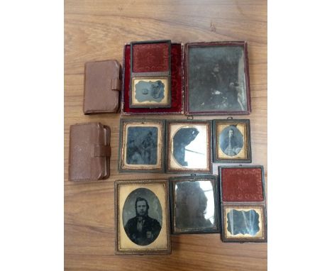 Eight early Victorian ambrotypes and daguerrotypes of men, women and children in Marocco cases and two packs of playing cards