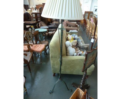 A modern cast metal standard lamp with green patina, on three splayed feet