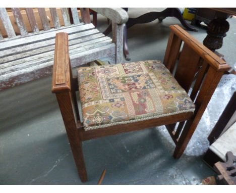 A vintage oak piano stool, with geometric cushion top