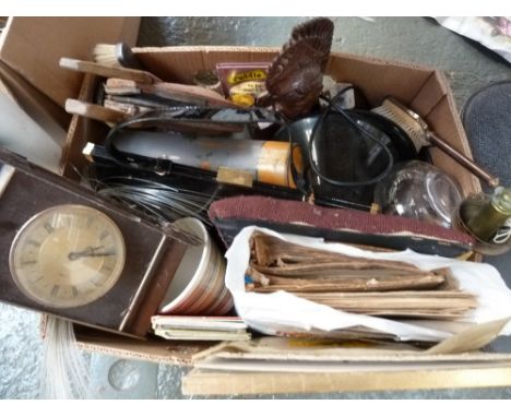 A mixed box of items including mantle clock, Flamex bellows, dresser brushes, oil lamp