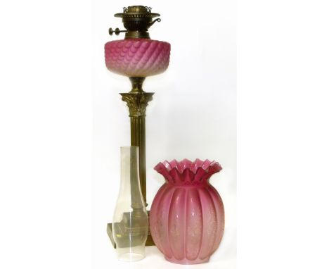Victorian brass oil lamp with ruby glass shade Condition reports are not available for our Interiors Sale.