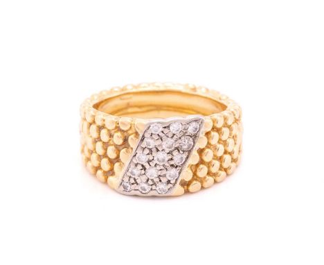 A dress ring with a stripe of 15 pave set diamonds on a textured bead band measuring 10mm tapering down to 5mm, ring size: N 