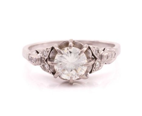 A diamond dress ring, featuring a claw set central round brilliant cut diamond measuring 6.82 x 3.98mm with 8-cut diamond set