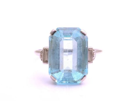 An aquamarine dress ring, comprising an emerald-cut aquamarine with pale blue body colour, approximately measuring 15.1 x 10.