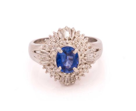 A sapphire and diamond cluster ring, featuring an oval-cut sapphire in vivid blue colour, approximately measures 6.8 x 5.5 x 