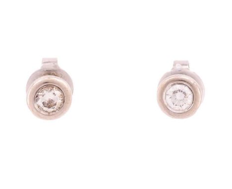 A pair of diamond stud earrings, each consisting of a brilliant-cut diamond of 3.5 mm in a collet, fitted with peg and butter