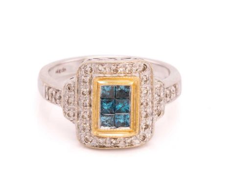 A diamond set white metal ring with a central panel of six princess cut blue diamonds within a border of round brilliant cut 
