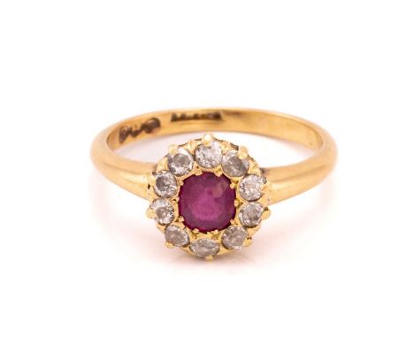 A ruby and diamond cluster ring, comprising a cushion-shaped French-cut ruby at the centre, encircled with a halo of old-cut 