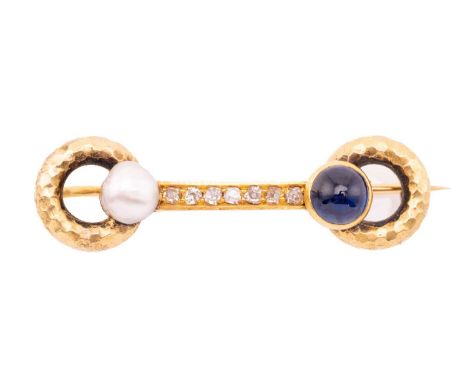 A gem-set bar brooch in form of a horsebit, with single-cut diamonds pavé-set on the straight bar, features a sapphire caboch