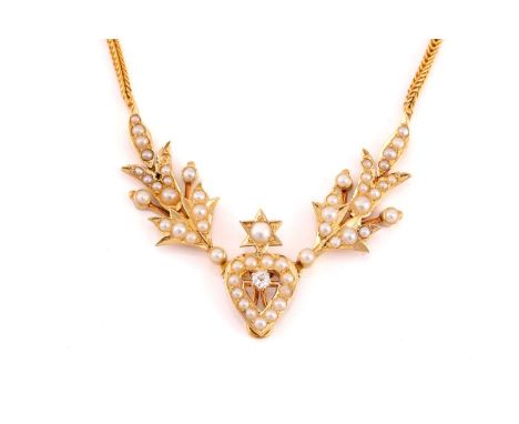 A late 19th century necklace encrusted with seed pearls, the hollow heart-shaped pendant crowned with a star motif and centre
