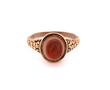 A Roman-style intaglio seal ring, set with an oval banded agate panel carved with a person in robe, collet set in an engraved