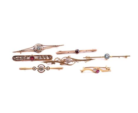 A group of Edwardian bar brooches, one crossover set with an old cut diamond and ruby, stamped 15ct 34.4mm wide, one with a d