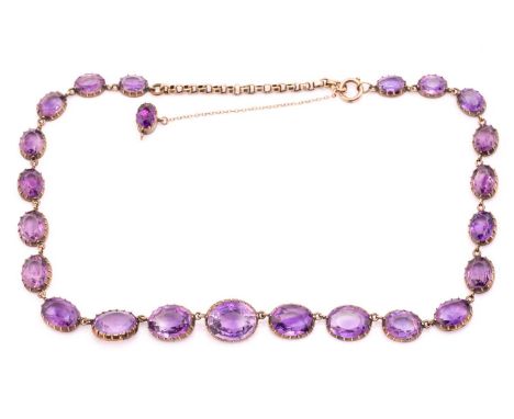 An amethyst rivière necklace, composed of twenty-three graduated and well-matched oval amethysts, mounted in open back pinche