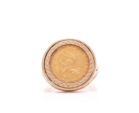 A South African coin inset signet ring in 9ct gold, the ring head mounted with a 1/10 oz Krugerrand 1980 coin, with floral em