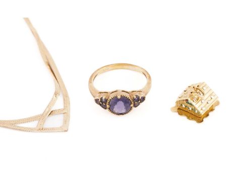 A 9ct yellow gold and purple gemstone ring, the round chequerboard-faceted central stone flanked with three smaller stones to