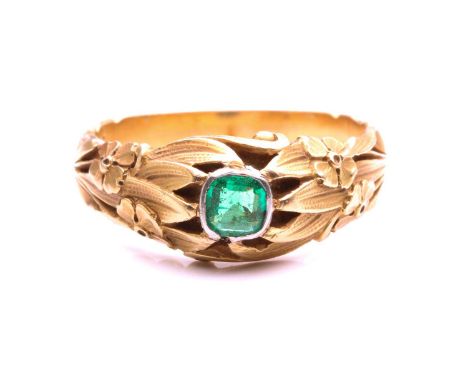 A floral engraved dress ring set with an emerald, collet-set with an emerald-cut emerald in bright green colour, approximatel