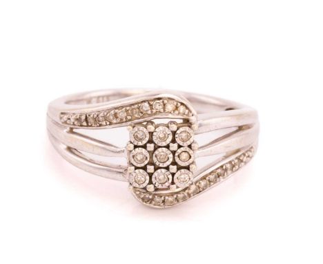 A diamond set panel-style ring, featuring a diamond set panel of nine diamonds with claw set 8- cut diamonds on the shoulders