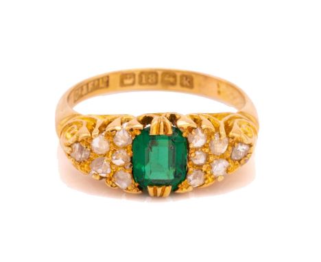 An Edwardian green garnet-topped doublet and diamond ring in 18ct gold, centred with an octagonal green doublet, flanked by r