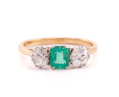 An emerald and diamond trilogy ring, claw-set with a square emerald-cut emerald with bright bluish-green body colour, approxi