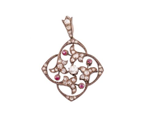 A late Victorian ruby and diamond openwork pendant, of quatrefoil outline, centred with an old-cut in a claw setting, surroun