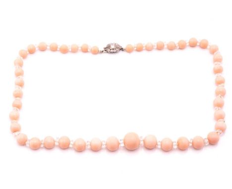 A pink coral bead necklace with a diamond-set clasp, comprising a string of graduated circular coral beads in pale pink colou