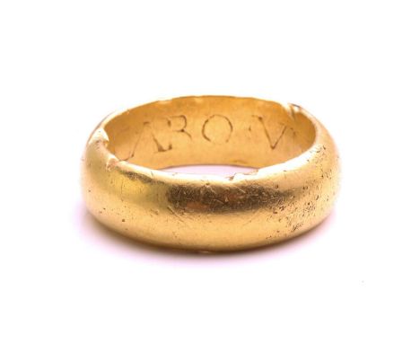 An Early 18th-century wedding ring, the thick plain D-section band engraved with a Latin phrase inside, 'Fient duo caro una' 