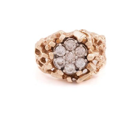 A seven stone diamond cluster ring; the round brilliant cut diamonds claw mounted within an open work abstract framework, to 