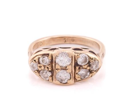 An eight stone diamond boat shaped cluster ring, set with round old cut diamonds, the D shaped ring shank stamped 9ct, ring s