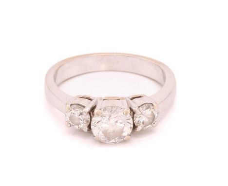 A three-stone diamond ring, with a central round brilliant cut diamond measuring 6.38mm flanked by two further brilliant cut 