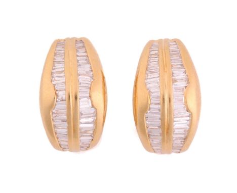 A pair of diamond hoop earrings, each featuring two rows of tapered baguette-cut diamonds in channel settings, fitted with po