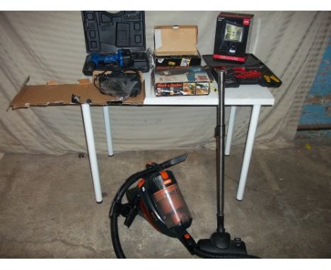 A VAX CYCLONE VAC TOGETHER WITH A BOXED SECURITY LIGHT AND A DRILL