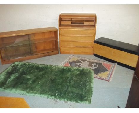 A ROLLER SHUTTER TEAK BUREAU, A VINTAGE GLAZED LOW WIDE TEAK BOOKCASE, AND A BKANKET BOX ETC.