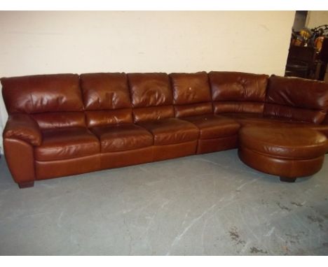 A BROWN LEATHER CORNER SOFA AND POUFFE