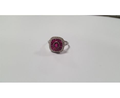 A PLATINUM RING SET WITH CENTRAL RUBY A HALO OF CALIBRE-CUT RUBIES AND A HALO OF DIAMONDS, SIZE L½