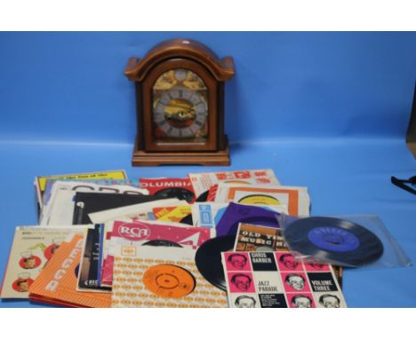 A MODERN TEMPUS FUGIT MANTEL CLOCK TOGETHER WITH A SMALL COLLECTION OF 45 RPM RECORDS / SINGLES TO INCLUDE THE TORNADOES, JOH