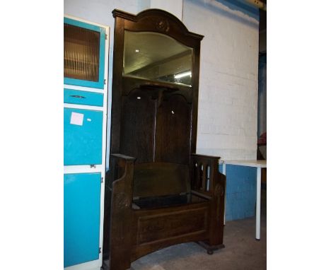 AN ANTIQUE OAK HALL STAND WITH BENCH AND STORAGE