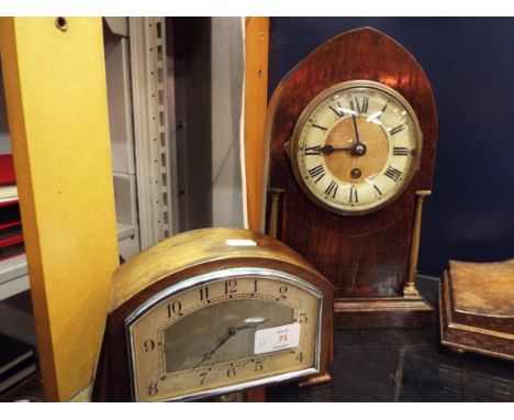 An oak cased lancet shaped mantel clock with enamelled dial and Roman numerals flanked by a pair of brass columns A/F togethe