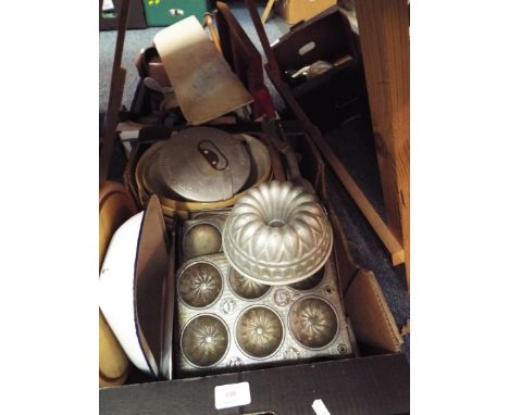 A box of vintage kitchenalia to include metal moulds, mixing bowls, bread board, kitchen tools etc